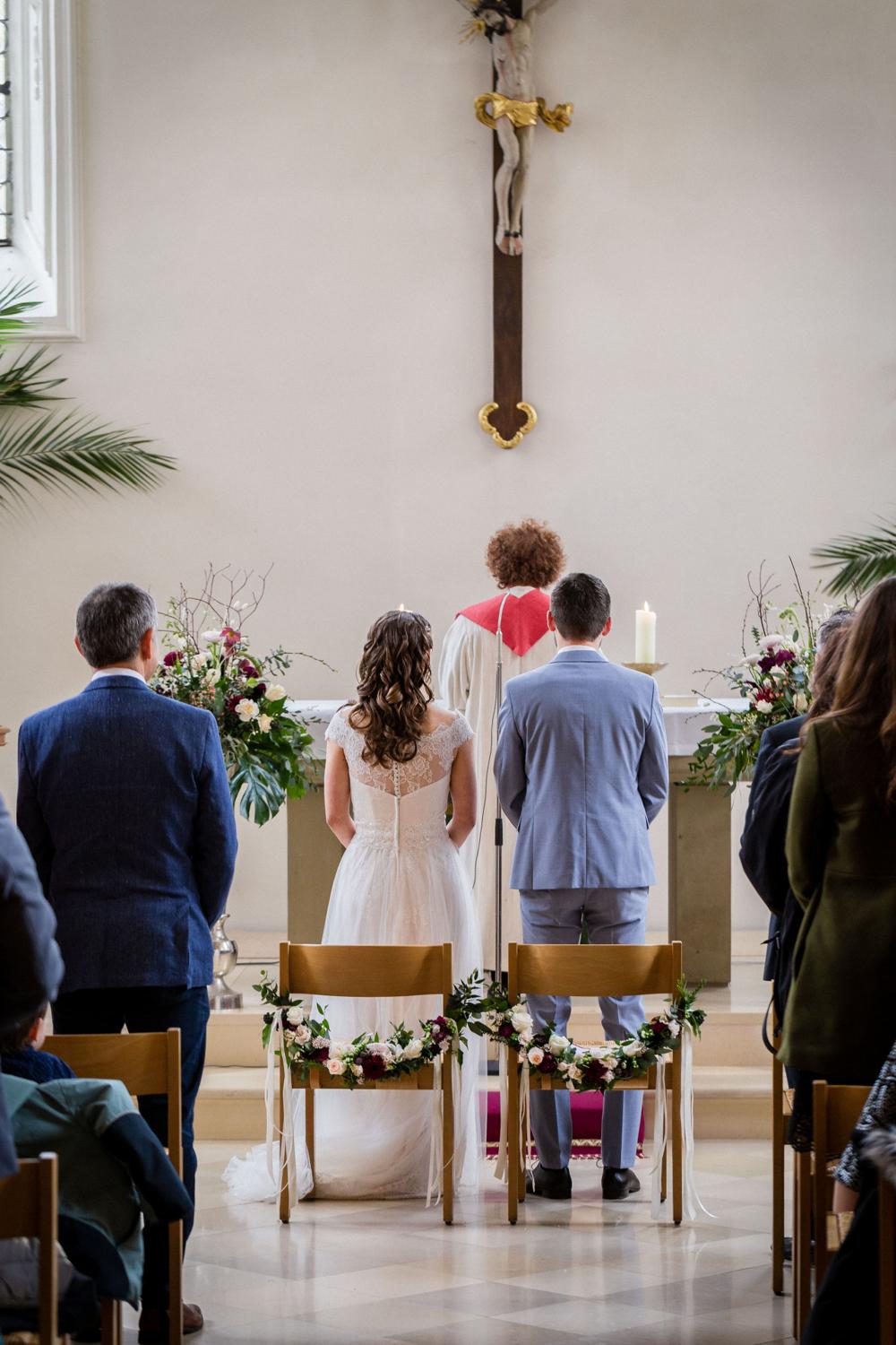 Brautpaar steht vor dem Altar unter dem Kreuz in Zwiefalten