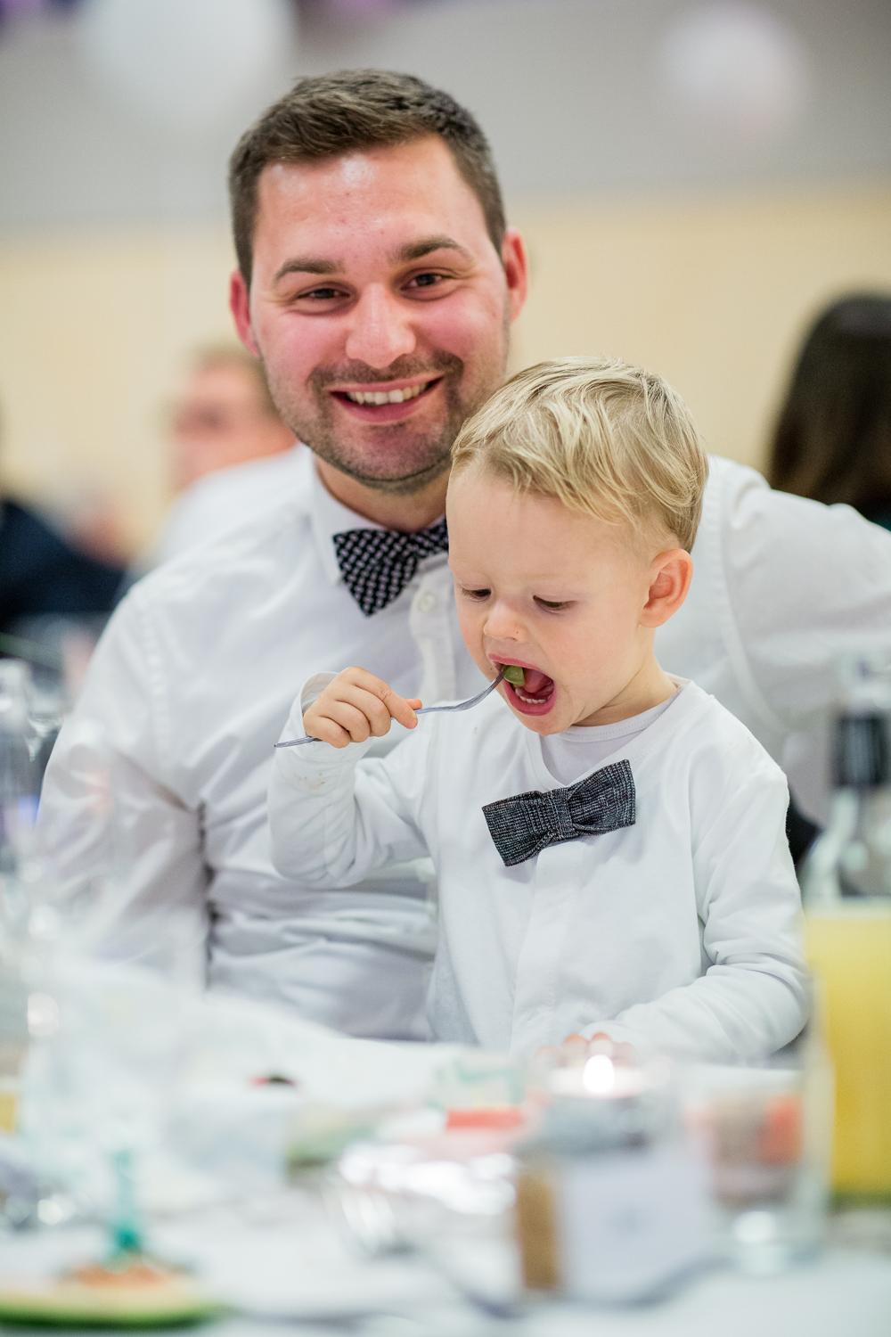 Gast mit Kleinkind auf dem Arm beim Hochzeitsessen in der Festhalle Gruol