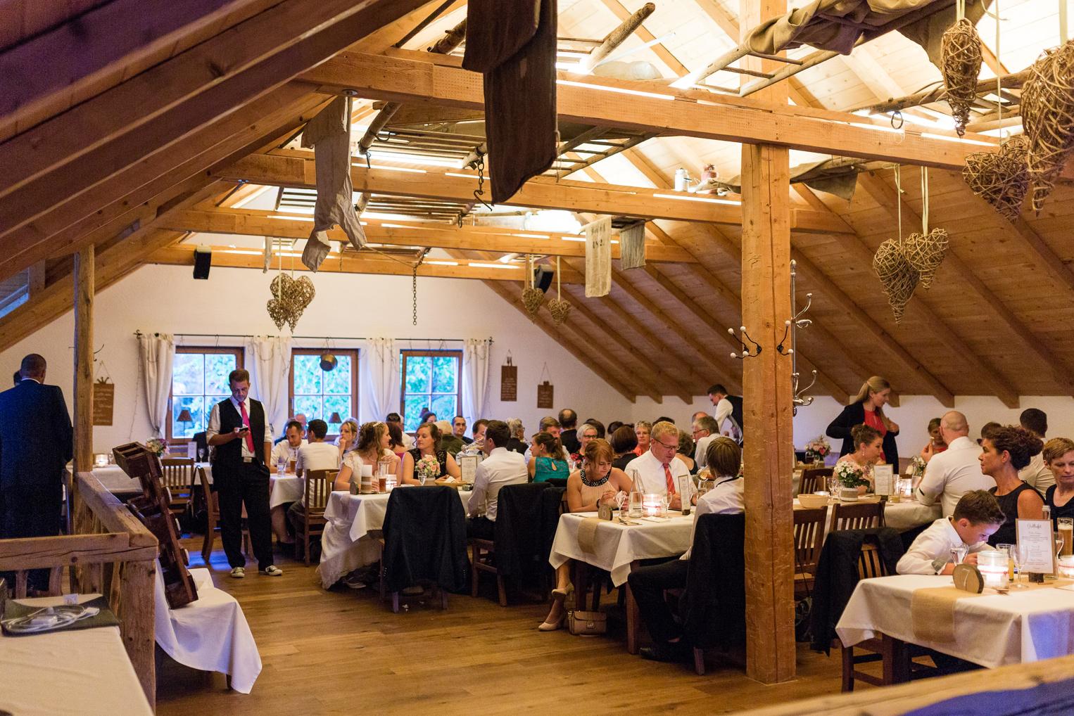 Gäste essen unter dem Dachstuhl im Festsaal der Hofschuir Bondorf