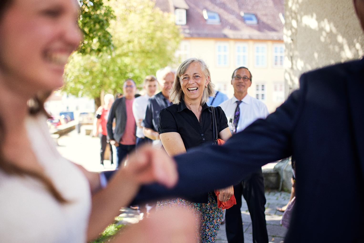 Gästin strahlt beim Begrüßen des Brautpaars in Dettingen